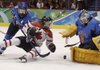  Finland's goalie Noora Raty blocks a shot as Canada's forward Jayna Hefford (16) and Finland's defenseman Jenni Hiirikoski (6) approach in the first period of a women's semifinal round ice hockey game game at the Vancouver 2010 Olympics in Vancouver, British Columbia, Monday