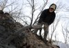 Brad Jones of Stark Masonary fills a trench with concrete Wednesday while preparing the footing for a new home being built by Habitat For Humanity of Benton County on Southwest “B” Street in Bentonville.

