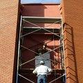 TALL ORDER - Louie Alterici, top, owner of Metco Glass, and Nick Ower work together Thursday to lift...