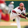 Arkansas starting pitcher Mike Bolsinger delivers a pitch during the Razorbacks’ season opener Feb. ...