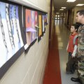 YOUNG AT ART - Heath Allen, right, looks at son Sky’s artwork on Thursday during a chili supper and ...