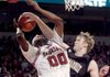 Vanderbilt center A.J. Oglivy slaps down a shot by Arkansas' Michael Washington in the first half Saturday at Walton Arena in Fayetteville.