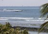 The ocean at Waikiki Beach starts to recede Saturday in Honolulu. A tsunami triggered by an earthquake in Chile swept ashore in Hawaii on Saturday, but the initial waves did not appear to cause significant damage.
