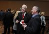 SPRINGDALE COMMERCE - Dwain Newman, left, chairman of National Home Center, talks with Knight Weis with Signature Bank on Friday during the Springdale Chamber of Commerce’s annual meeting and dinner at the Northwest Arkansas Convention Center in Springdale. Newman won the Chamber’s Civic Service Award.