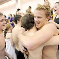 Bentonville junior Pearson Gean, center, is hugged by teammate Nathan Bracy after Gean led the Tiger...
