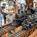 Davy Nelson, 4, left, and Russell Rager, 2, watch one locomotive pull ahead of another while crossin...