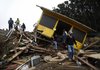 People survey a destroyed house Sunday after an earthquake in Curanipe, about 241 miles southwest of Santiago, Chile. An 8.8-magnitude quake struck central Chile early Saturday.