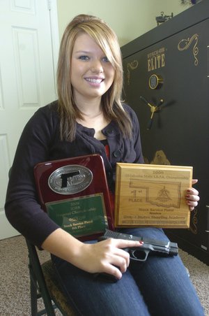 Nikki Pinto, 17, shows her plaque from the International Defensive Pistol Association national championship and Oklahoma state championship.