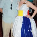 Jennifer Simmons, with husband John Simmons, models her dress at the Arts Center of the Ozarks Beach...