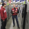 Brett Smith, right, a sales specialist with Lowe’s in Rogers, talks Saturday with Scott Higgins of P...