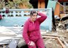 Victoria Hernandez cries outside her parents’ house in Dichato, Chile, on Monday. Hernandez believes that her parents, though missing since Saturday’s 8.8-magnitude earthquake, are alive.