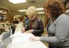 STAFF PHOTO J.T. WAMPLER 
Washington County Judge Marilyn Edwards, left, signs the paperwork to run for re-election Monday while Jennifer Sharpshair, deputy county clerk, assists. Edwards was the first person to get her paperwork in Monday, the first day for candidates to file to run for elected office.