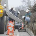 A crew from Sweetser Construction pours a concrete curb Tuesday on Martin Luther King Jr. Boulevard ...