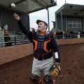 Rogers Heritage catcher Spanky Purdy tosses the ball back to Mayor Steve Womack, not pictured, while...