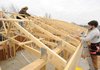 STAFF PHOTO ANDY SHUPE 
Perry Cheever, left, and Zach Shipman, both carpenters with VLS Construction in Bruno and both of Yellville, measure rafters for fitment of metal roofing components Friday while working on a kitchen addition of the Farmington Senior and Community Center.
