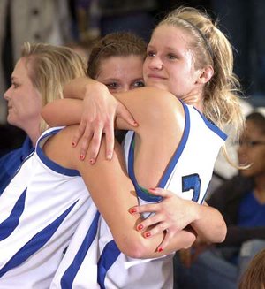 STAFF PHOTO MARC F. HENNING 
Rogers High seniors Morgan Hook, left, and Jazmin Coultas embrace during the final minutes of their Feb. 23 game against Springdale Har-Ber in Rogers. Hook and Coultas played their final regular-season game as Lady Mounties.