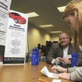 STAFF PHOTO J.S. WEDGEWORTH 
Shanda Attaway, right, writes a mock check Wednesday to Wayne Perkins ...