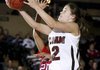 Siloam Springs' Laken Grigg drives around McClellan's Janae Duhart to the basket during the first half Thursday during the 5A State Tournament at Alma High School.
