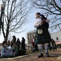 JoAnn Tyler of the Ozark Highlanders Pipe Band plays bagpipe music before a crowd of residents and s...
