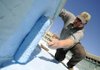 PAINT THE TOWN BLUE - Jimmy Walden, Bentonville Parks and Recreation Department crew leader, gives the fountain on the square its annual coat of ocean blue paint Thursday while preparing for the inaugural First Friday event of the season in downtown Bentonville. Walden said the fountain will be operating for today’s event.