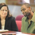 Johnny Ray Balentine, right, of Springdale smiles Tuesday alongside one of his attorneys, Leanna Hou...