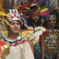 COLOR OF CULTURE - Andrea Alvarado, 14, of Rogers waits to perform with the Aztec Dancers of St. Vin...