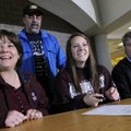 SOCCER SIGNING - Michelle Mayne-Nicholls, 17, center, reacts from the applause of her teammates Thur...