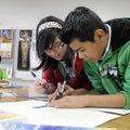 DRAW PARTNER - Kristen Salas, 11, left, and Gerzon Rodriguez, 12, work on their Egyptian-themed mura...