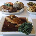 Grilled salmon, foreground, covered with maple-orange marmalade glaze and served on a cedar plank an...