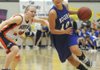 Rogers High’s Morgan Hook, right, drives around Heritage’s Lindsey Wood on Feb. 26 in Rogers.
