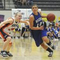 Rogers High’s Morgan Hook, right, drives around Heritage’s Lindsey Wood on Feb. 26 in Rogers.
