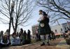 JoAnn Tyler of the Ozark Highlanders Pipe Band plays bagpipe music before a crowd of residents and students from Baker Elementary School in early March, part of Downtown Bentonville's First Friday series. 