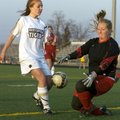 Green Forest goalie Elicia Hankins dives to stop a shot on goal attempt by Bentonville’s Kennedy Cab...