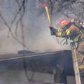 AVOCA FIRE - A firefighter with Northeast Benton County Fire Department works to ventilate a home Fr...