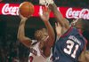 Arkansas guard Julysses Nobles drives past Ole Miss defenders Murphy Halloway (31) and Zach Graham (32) to tie the score in the game’s final seconds. A later try by Nobles was partially blocked and fell short.