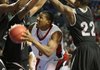 Arkansas State’s Jeremy Thomas finds himself surrounded by UALR defenders, including Solomon Bozeman (22) and Courtney Jackson (12), in the first half Saturday in Hot Springs.