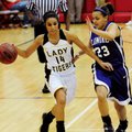 Prairie Grove’s Julie Rutherford, left, drives around Lonoke’s Cara Neighbors during the first half ...