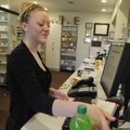 Teshia Sander, pharmacy tech at Lowell Pharmacy, scans in a box of cold medicine Wednesday containin...