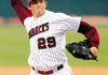 Arkansas freshman DJ Baxendale delivers a pitch during the Razorbacks’ Feb. 23 game against Ball State in Baum Stadium in Fayetteville.