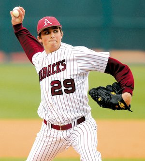 Arkansas freshman DJ Baxendale delivers a pitch during the Razorbacks’ Feb. 23 game against Ball State in Baum Stadium in Fayetteville.