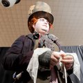 Eric Burton bandages his thumb Saturday for his role as the Mad Hatter at the Arkansas Anime Festiva...