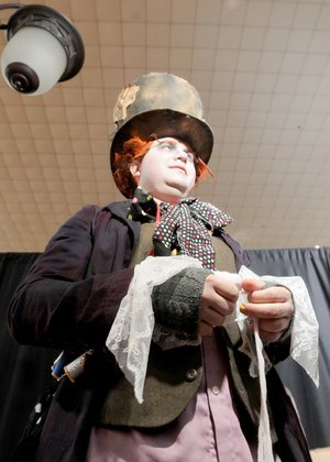Eric Burton bandages his thumb Saturday for his role as the Mad Hatter at the Arkansas Anime Festival at the Clarion Hotel in Bentonville.
