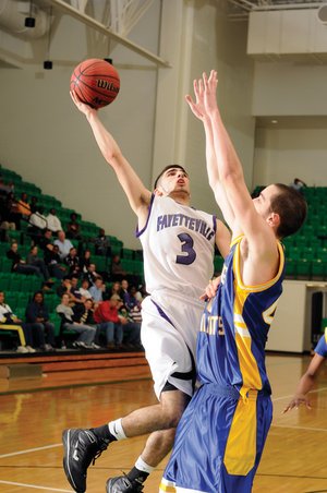 Fayetteville guard Kikko Haydar, left, shoots over North Little Rock’s Mike Evans in the second half of the Class 7A State Tournament semifinals on Saturday in Clair Bates Arena in Van Buren. Haydar had 24 points in the Bulldogs’ 49-41 victory. 