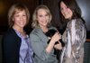 Wine Opener volunteer Denise Martin, from left, introduces a 5 /2-week-old black Labrador puppy to Cystic Fibrosis Foundation supporters Christal Tuller and Melinda Yeaman during the VIP reception Feb. 26. The puppy was one of the live auction items during the fundraiser, and sold for $900.