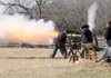 Members of the Northwest Arkansas Historical Association fire a canon Saturday near Elk Horn Tavern at Pea Ridge National Military Park.