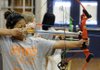 STAFF PHOTO ANTHONY REYES 
Kinna Laju, 14, aims her bow at a target during a physical education class Thursday at Southwest Junior High School in Springdale. The class is in its two-week archery unit where they learn the sport.