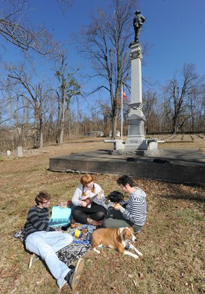 STAFF PHOTOS ANDY SHUPE 
Members of the newly formed band “Ukulelephobe,” from left, Rodney Wilhite, Erika Wilhite and Jacob Shores, rehearse Thursday alongside the Wilhites’ dog, Punkin, at the Confederate Cemetery in Fayetteville.