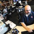 STAFF PHOTO MARC F. HENNING 
Rogers police and fire dispatcher Joe Jacques takes a police emergency...