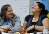 STAFF PHOTO ANTHONY REYES 
Risee Chandler, left, tutor with the Springdale School District, laughs with Jenifer Mejia, 16, during a tutoring session Wednesday at George Junior High School. The after-school activity is designed to give more time to prepare for exams.