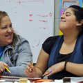 STAFF PHOTO ANTHONY REYES 
Risee Chandler, left, tutor with the Springdale School District, laughs ...